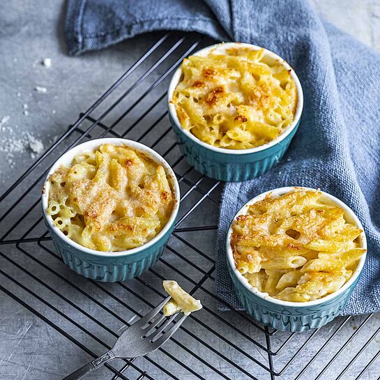 Mini Auflaufformen mit Rigatoni Quattro Formaggi gefüllt. Die Nudeln werden mit Taleggio, Parmesan, Mozzarella und einer Zwiebel-Sahne-Mischung überbacken. 