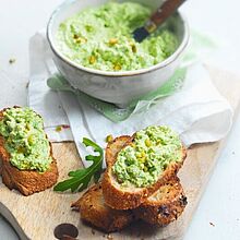 Geröstetes Brot mit cremigen Ziegenfrischkäse-Dip, verfeinert mit Rucola Salat