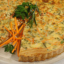 Frische Karotten-Zucchini-Tarte aus dem Ofen mit feinem Ziegenkäse und frischen Kräutern