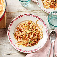 Schüssel mit Pasta und italienischer Tomaten Käse Soße. Leckerer MILKANA Schmelzkäse macht die Soße cremig zart