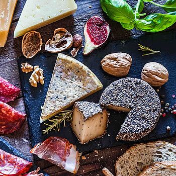 Holzplatte bestückt mit vielen feinen italienischen Käse- und Wurstspezialitäten